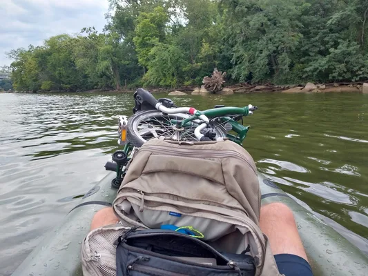 My perspective in packraft facing Roosevelt island with folding bicycle lashed to bow and backpack between legs.